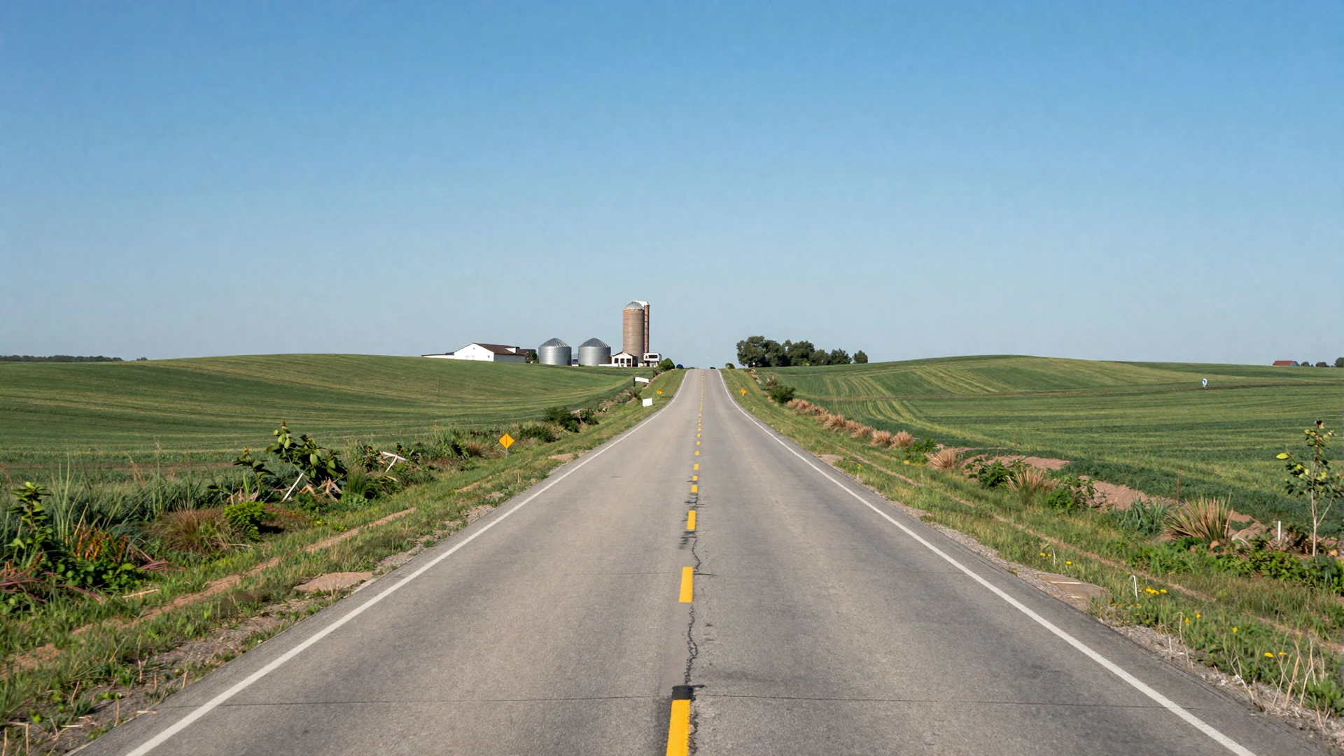 Iowa interstate highway with rolling green hills and farm silo - trucker dating Iowa lifestyle