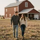 Chris and partner walking near an Iowa farmstead - trucker dating Iowa success