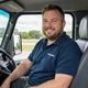 Robert, Georgia truck driver smiling in his cab - DriveMatch success story