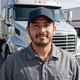 Carlos, California OTR truck driver in front of his Freightliner - DriveMatch success story