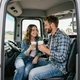 Tyler and Jess sharing coffee in a truck cab - Ohio trucker dating success