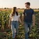 Chris and his partner walking near a Nebraska cornfield - trucker dating success