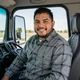 Tyler and Angela standing by a Kenworth truck - Texas trucker dating success