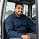 Carlos, regional truck driver smiling in his cab - Houston DriveMatch success