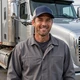 Chris, regional truck driver smiling by his truck - Dallas DriveMatch success story