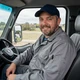 Tom, Pennsylvania regional truck driver smiling in his cab - DriveMatch success story